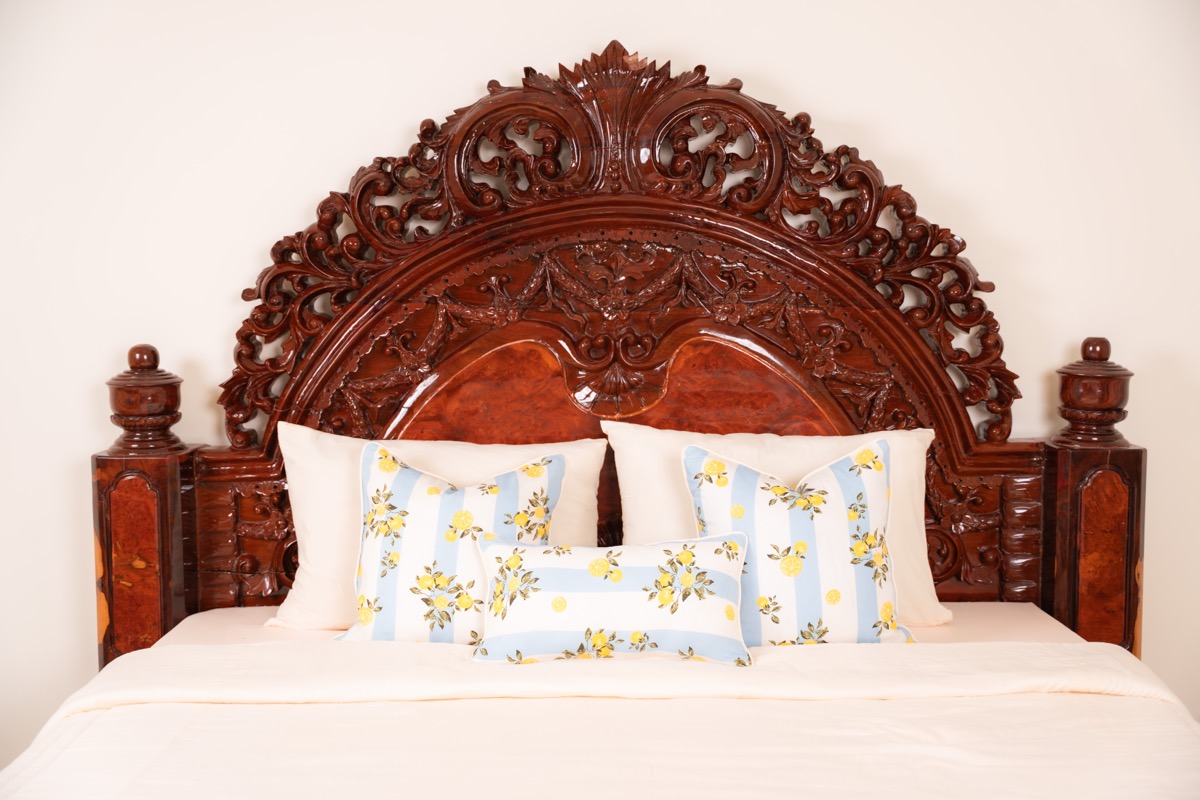 Lemon print pillows on carved bed