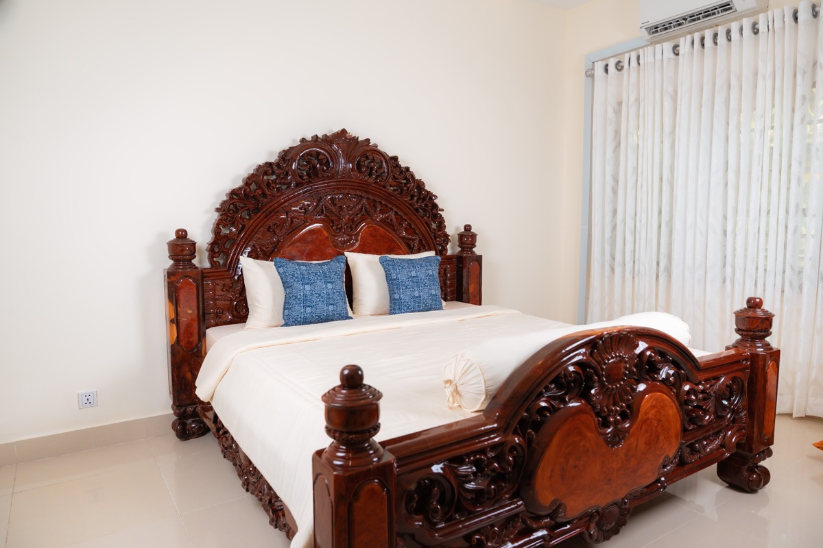 Blue indigo pillows on carved bed